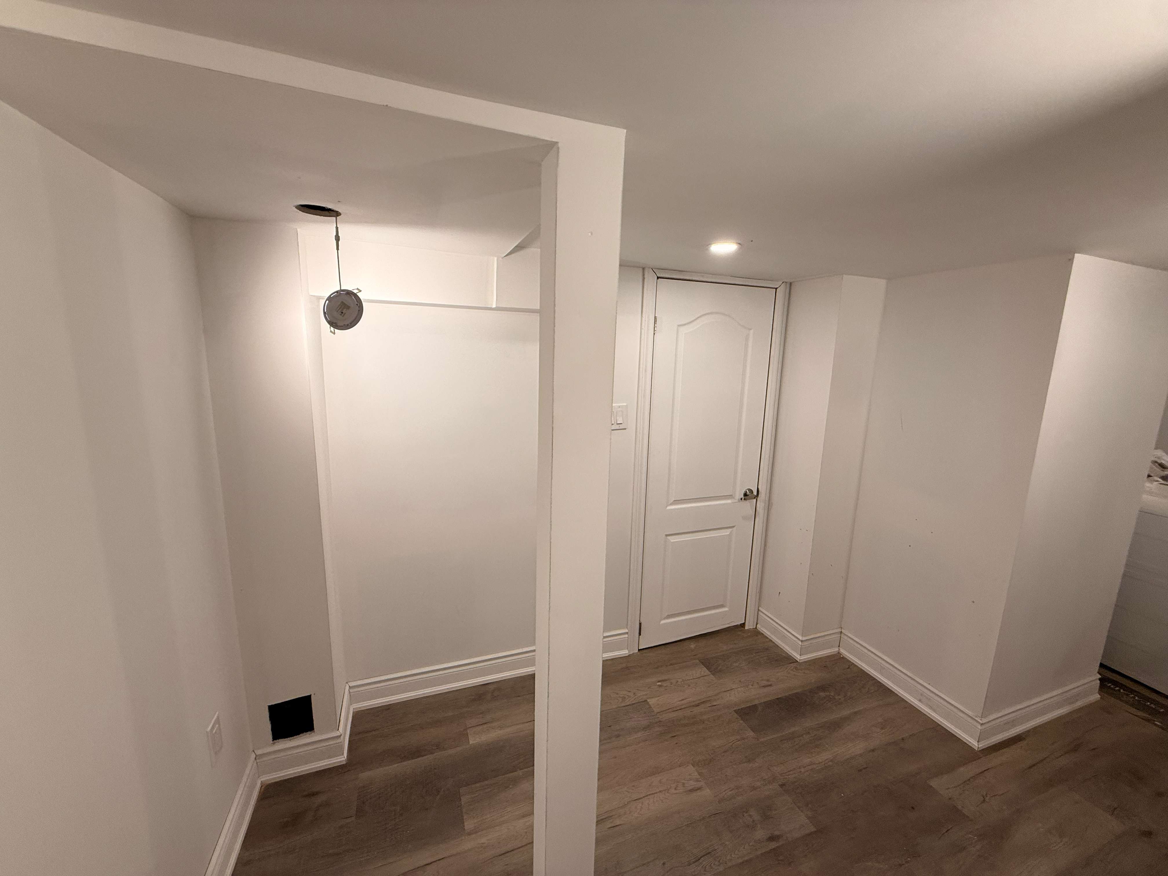 Renovated hallway with finished trim, doors, and pot lights